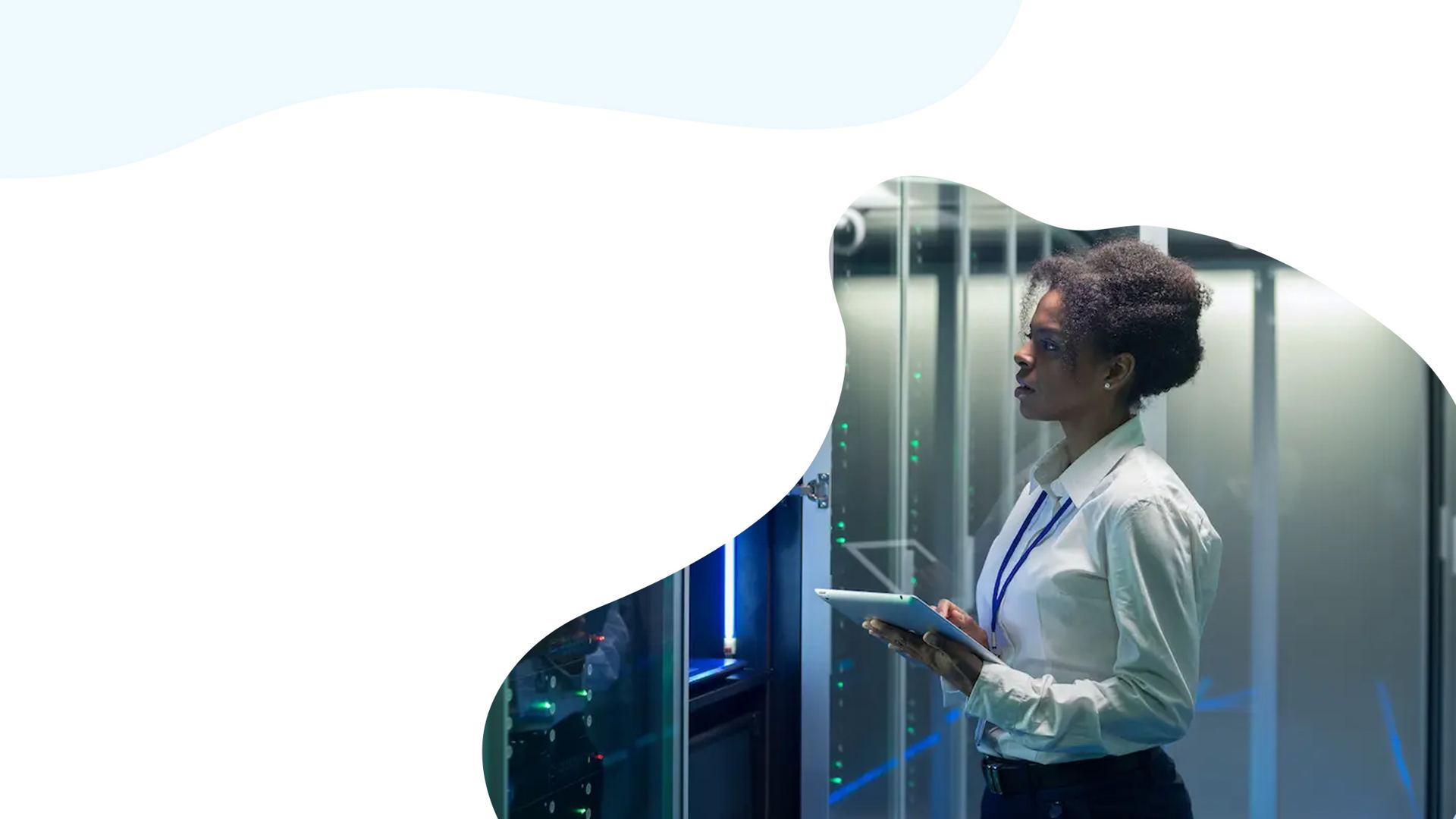 Engineer with a tablet in a server room